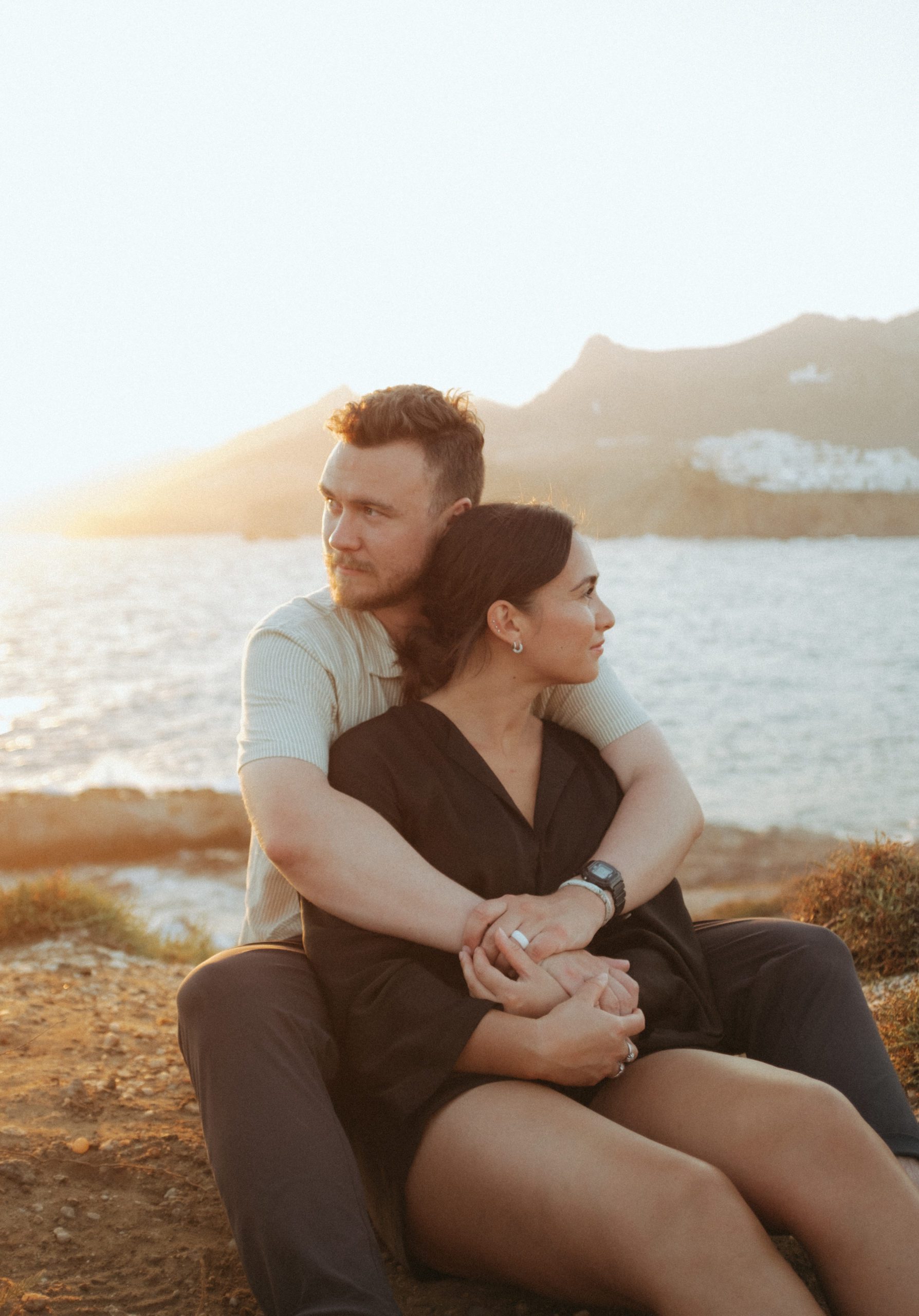 Couple sitting on the coast of Greece