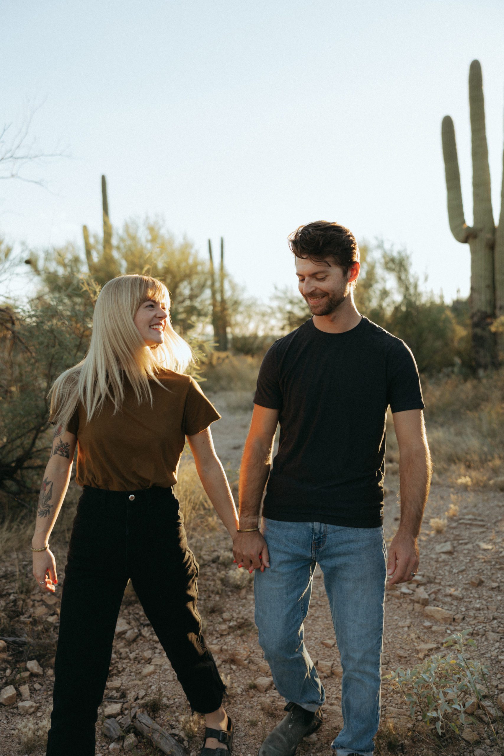 couple in the desert holding hands