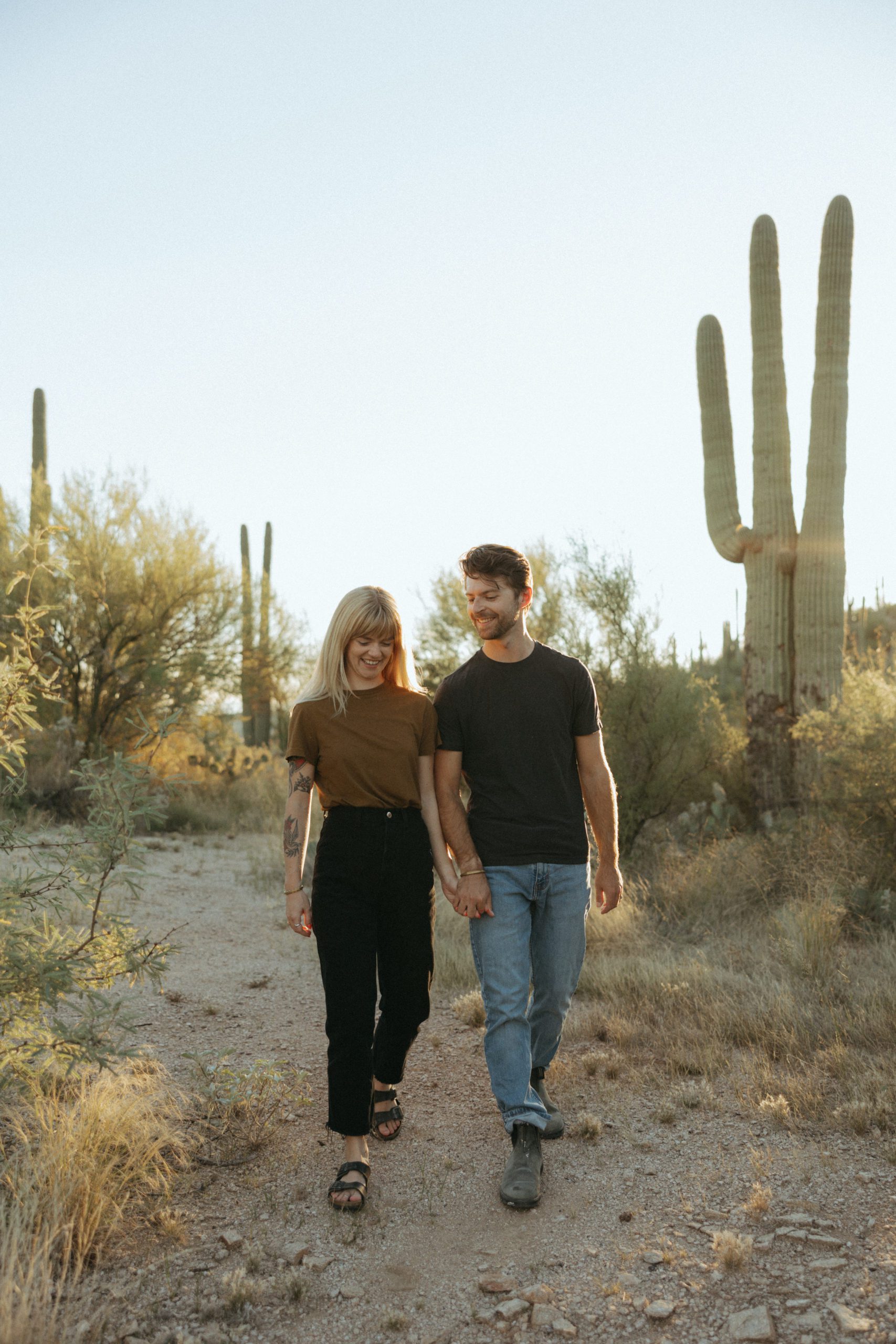 couple walking holding hands in desert