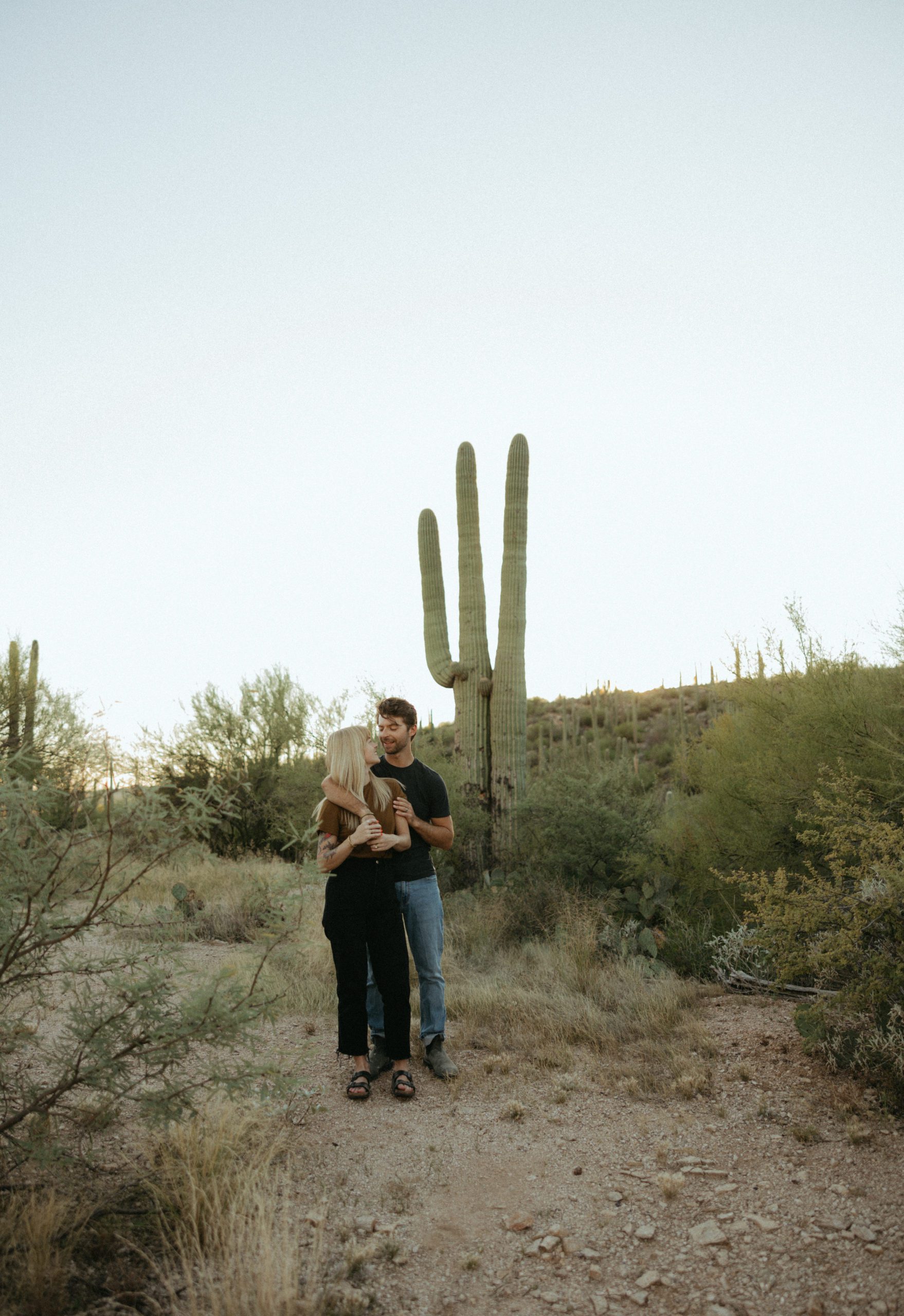couple in desert by a cactus
