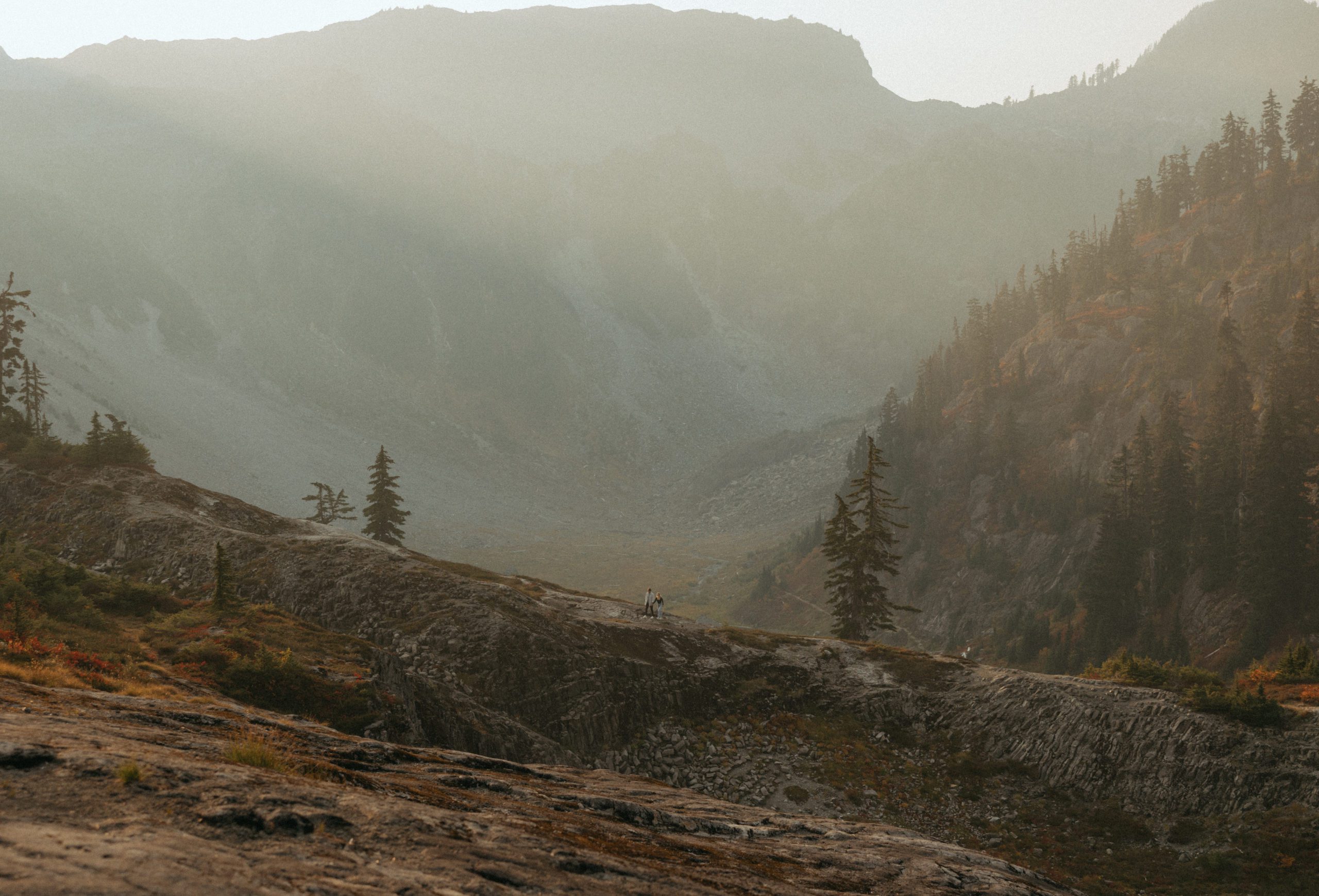 Couple in the north cascade mountains walking on a ridge