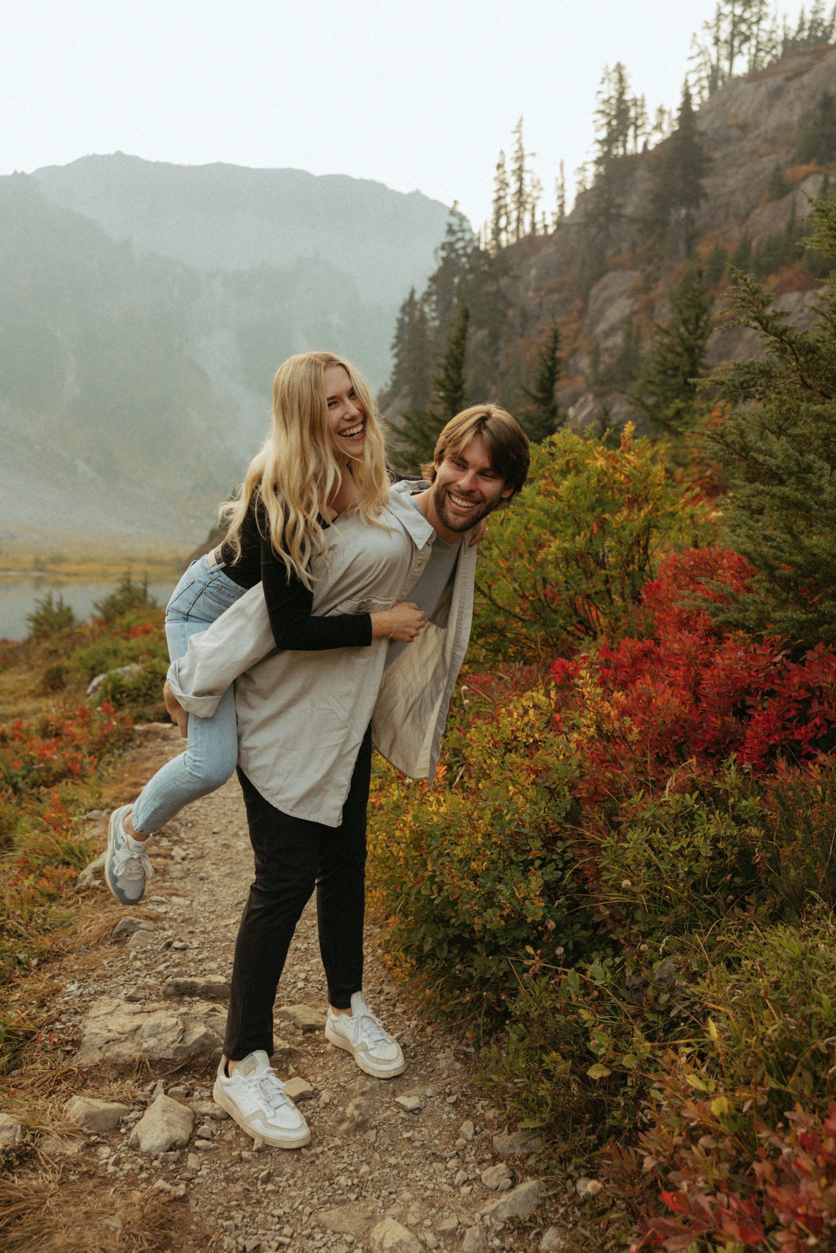 Couple in the north cascade mountains piggy back ride