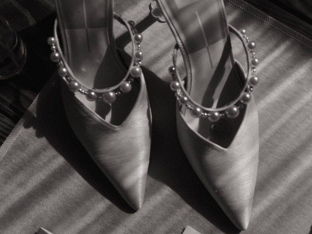 black and white photo of brides wedding shoes 